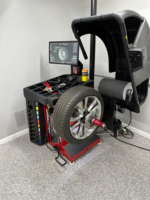 A wheel balancer with its display screen in the Car Doctor+ bay