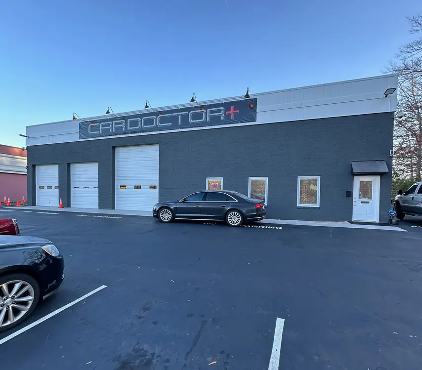 The Car Doctor+ building on Germanna Highway: charcoal brick, three bay doors and the CAR DOCTOR+ sign
